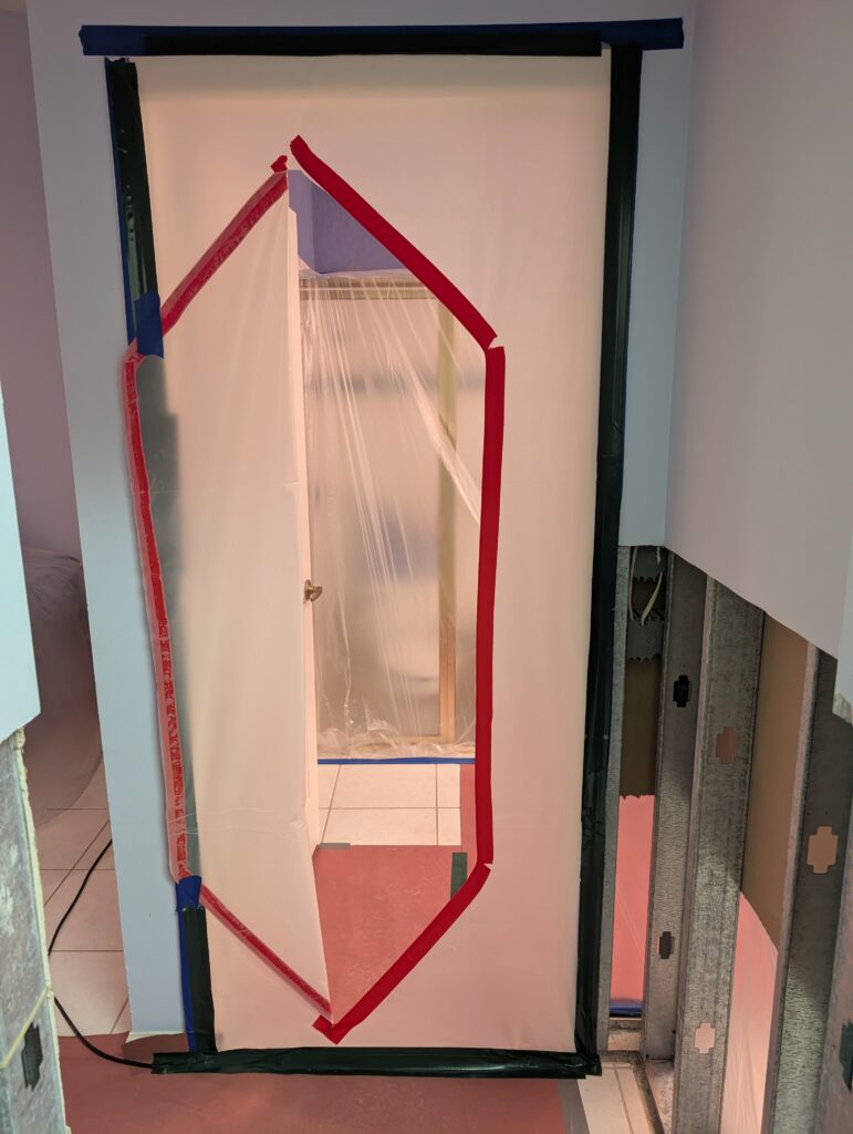 plastic containment barrier with zipper door used during mold remediation