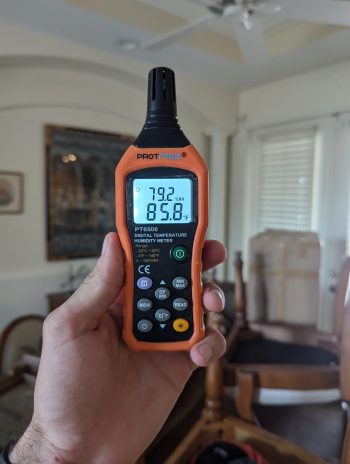 moisture meter detecting water damage inside residential home