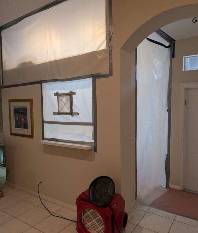 mold remediation containment with plastic barrier and negative air machine