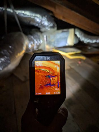 thermal camera detecting hidden moisture near ductwork during water damage inspection