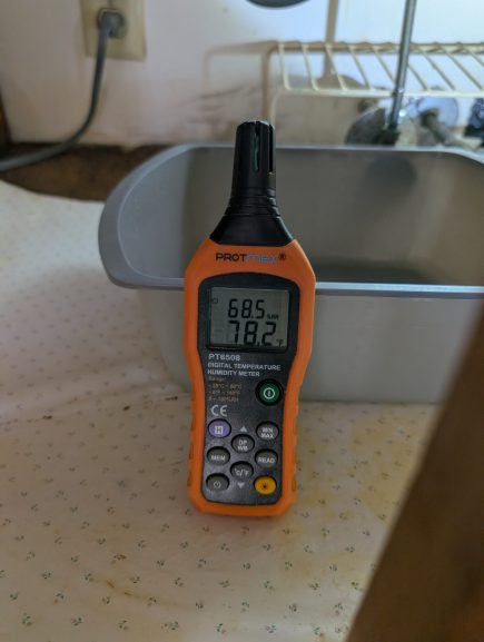 Humidity and temperature readings taken near sink during water damage inspection in Palm Beach County