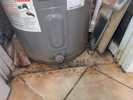 Water damage around water heater causing flooring and baseboard deterioration in Palm Beach County home