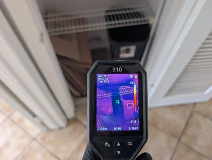 Thermal imaging detecting hidden moisture inside closet after water damage in Palm Beach County home