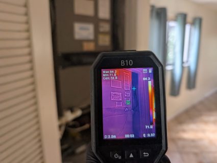 Thermal imaging camera detecting hidden moisture near HVAC closet in Palm Beach County home